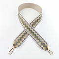 Close-up of ethnic wavy pattern woven strap with gold metal lobster clasps - Grey-Beige