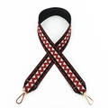 Close-up of ethnic wavy pattern fabric wide bag strap with gold metal lobster clasps - Black with Brick Red