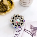 Close-up of luxury rhinestone phone grip with iridescent crystal on elegant tray - Multicolor Sunflower - Black Base