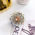Macro detail of luxury rhinestone pop socket with champagne crystal and radiant floral design - Sunflower Gold - Textured Base
