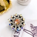 Close-up of luxury rhinestone phone socket with amber crystal and multi-color accents - Sunflower Gold - Black Base