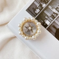 Detail of a round folding phone stand with faux pearls and golden star on a white book - No.12 Vintage Star / White