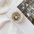 Detail of a gold heart phone socket with elegant faux pearl border on white fabric - No.10 Dark Heart / White