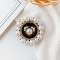 Macro detail of rhinestone and pearl heart phone grip on a minimalist fabric background - No.10 Dark Heart / Black