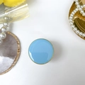 Detail of light blue circular phone grip with elegant gold edge on white tray - Round Electroplated Stand / Macaron Light Blue