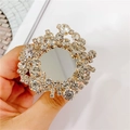 Golden foldable phone socket with rhinestones and central mirror shown in hand - Gemstone Holder No. 25 / White Full Diamond Mirror