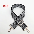 Close-up of black and white paisley embroidered bag strap with golden metal hardware - No.18 Black Base