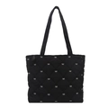Black quilted tote bag with white bow embroidery and diamond stitching details - Black