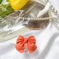 Detailed close-up of a vibrant orange bow phone grip holder on a stylish vintage tray - Transparent Stand-Large Bow-Orange