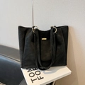 Classic black high-capacity tote bag featuring matte leather and golden hardware accents - Black