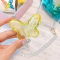 Macro detail of yellow crystal butterfly phone grip with iridescent beaded charm strap - Yellow