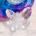 Macro shot of transparent crystal butterfly phone grip with faceted cut diamond finish - Clear