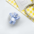 Macro shot of cute light blue bear phone stand with heart details on a bright background - Blue