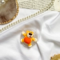 Detail of yellow cartoon bear phone grip on transparent base with decorative props - Color Contrast Bear / Yellow