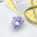 Close-up of purple cartoon bear phone grip with heart paw details and transparent base - Purple