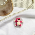 Close-up of cute pink bear cartoon expanding phone socket on aesthetic white fabric - Color Contrast Bear / Rose Red