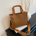 Brown leather tote bag with geometric pattern, top handles, and crossbody fabric strap - Brown
