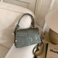 Retro dark green crossbody bag with vertical stripe texture and knotted handle on sofa - Green