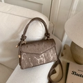Retro brown textured small square handbag with golden print on a soft home sofa - Brown