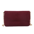 Minimalist burgundy suede crossbody bag with gold chain strap on white background - Red