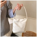 Close-up of Hope and Future embossed design on white nylon tote bag surface - Off White