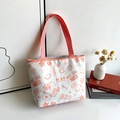 Borsa tote in tela bianca con stampe graffiti arancioni e manici rossi tessuti - Rosa