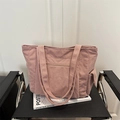 Sac cabas en velours côtelé rose avec poche zippée et rabat latéral sur chaise - Rose