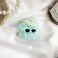 Blue plush monster phone grip with green crochet hat and mint sunglasses on white fabric - Green