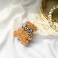 Brown plush bear phone grip with houndstooth bow tie in a cozy aesthetic setting - Plush Airbag Stand / Brown Bowtie Bear