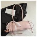 Pink baguette bag with white lace bow and long silk ribbons on soft textured background - Pink