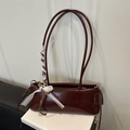 Minimalist burgundy baguette shoulder bag with elegant lace bow and glossy finish - Red