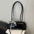 Black glossy patent leather baguette bag with white lace bow and dual slim straps - Black
