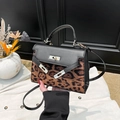 Chic leopard print handbag with black leather trim and gold twist-lock closure - Black