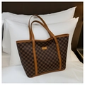 Detail of a brown checkered tote bag featuring golden logo plate and fine stitching - Brown