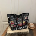 Black leather tote bag with colorful graffiti and bear print on a soft beige scarf - Black