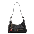 Glossy black hobo tote bag with gold hardware and a cute character pendant on a white background - Black