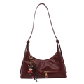 Minimalist burgundy half-moon crossbody bag with decorative zipper and cartoon bull charm - Red