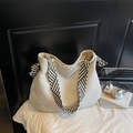 Large beige corduroy tote bag with woven shoulder strap shown with lifestyle accessories - White