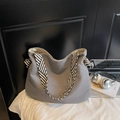 Grey pleated corduroy tote bag with black and white striped shoulder strap and knot detail - Gray