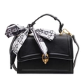 Minimalist black leather handbag with a gold ring buckle and decorative silk scarf - Black