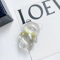 Vue détaillée d'un support de téléphone ours transparent avec nœud vert clair - Jaune