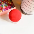 Minimalist red spherical pop-up phone grip with transparent base in a stylish setting - Red