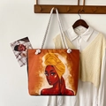 Detail of artistic African woman print on orange canvas tote bag with woven rope handles - Pattern 5