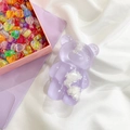 Cute purple resin bear phone grip with white cloud patterns on a soft white cloth - Purple Cloud Bear