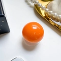 Collapsible phone grip stand featuring a vibrant glossy orange sphere design and base - Orange
