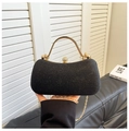 Close-up of black glitter evening clutch with gold handle and sparkling rhinestone lock - Black