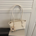 Minimalist beige leather tote bag with long straps and plush animal charm for daily commute - With Pendant / White