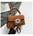 Detail of brown suede handbag featuring a scrunchie handle and rhinestone buckle accent - Brown