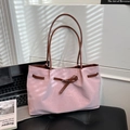 Pink tote bag with brown handles and front buckle strap decoration in lifestyle setting - Pink Without Charm