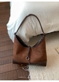 Detail of caramel suede hobo bag featuring contrast stitching and a round metal buckle - Coffee